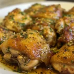 ['Close-up side view of Maple Mustard Chicken, showcasing juicy chicken pieces with a golden-brown glaze.', 'Juicy chicken pieces coated in a rich maple mustard sauce, photographed from the side.', 'Delicious Maple Mustard Chicken with a glossy finish, captured in a detailed side view.', 'Side view of plated Maple Mustard Chicken, highlighting its succulent texture and vibrant glaze.']