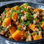 ['Close-up view of a savory turkey and sweet potato hash in a bowl.', 'Side view of a colorful turkey hash with diced sweet potatoes and greens.', 'Juicy turkey and sweet potato dish garnished with fresh parsley.', 'A vibrant mix of ground turkey, sweet potatoes, and spinach in a dish.']