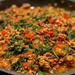 ['Close-up view of a savory ground turkey and spinach dish in a skillet.', 'Juicy cooked ground turkey mixed with fresh spinach and herbs in a frying pan.', 'Hearty one-skillet meal featuring ground turkey, spinach, and seasonings.', 'Colorful skillet filled with ground turkey and sautéed spinach garnished with cheese.']