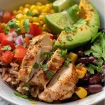 ['A close-up view of a high protein chicken burrito bowl with vibrant ingredients.', 'Side view of a colorful chicken burrito bowl featuring diced chicken and fresh vegetables.', 'Juicy chicken burrito bowl showcasing layers of rice, beans, and toppings like avocado.', 'An appetizing chicken burrito bowl filled with healthy ingredients and garnished with cilantro.']
