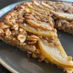 ['Close-up of golden brown cinnamon pear pancakes stacked on a plate.', 'Side view of fluffy pancakes topped with sliced pears and a sprinkle of cinnamon.', 'Deliciously plated cinnamon pear pancakes with a drizzle of syrup and butter.', 'Juicy pancakes made with pears, displayed with a hint of cinnamon and a warm glow.']