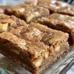 Close-up view of freshly baked apple cider blondies with a golden-brown texture.