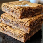 Close-up of brown butter ginger molasses blondies with a glistening top.