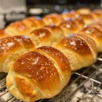 Close-up of warm, fluffy yeast rolls with a golden crust.