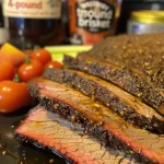 Close-up of braised brisket with a glossy bourbon-peach glaze.