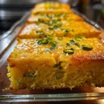 Close-up view of a slice of jalapeno cornbread, showing its texture and toppings.