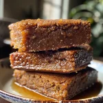 Close-up view of gingerbread bread pudding with a golden brown crust.