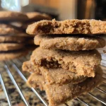 Close-up of gingerbread cookies with intricate decorations and spices.