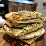 Close-up of a fluffy pita filled with zucchini and old bread.