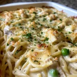 Close-up view of turkey tetrazzini with creamy sauce and melted cheese.