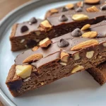 Close-up view of chocolate almond protein biscotti, showcasing its crunchy texture and chocolate chips.