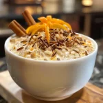 A close-up side view of creamy wild rice pudding with a brown sugar brûlée topping.
